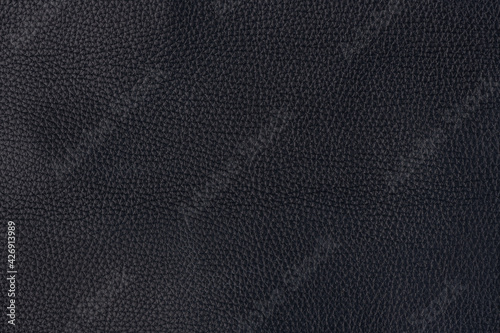 Black textured smooth leather surface background, large grain