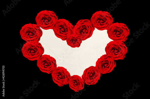 Heart-shaped frame of red roses for text on a black background