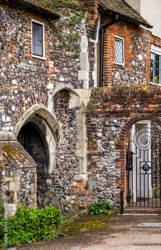Fototapeta Naklejka Na Ścianę i Meble -  The exterior of an ancient flint built building on the bank of the River Wensum in the city of Norwich