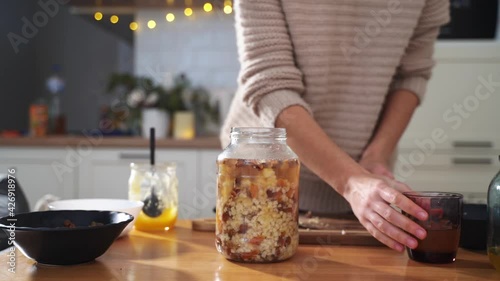 Woman cooking at home kutia - traditional ukrainian orthodox christmas food. slow living, merry season.  photo