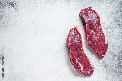 Fresh Raw sirloin beef meat steak. white background. Top view. Copy space
