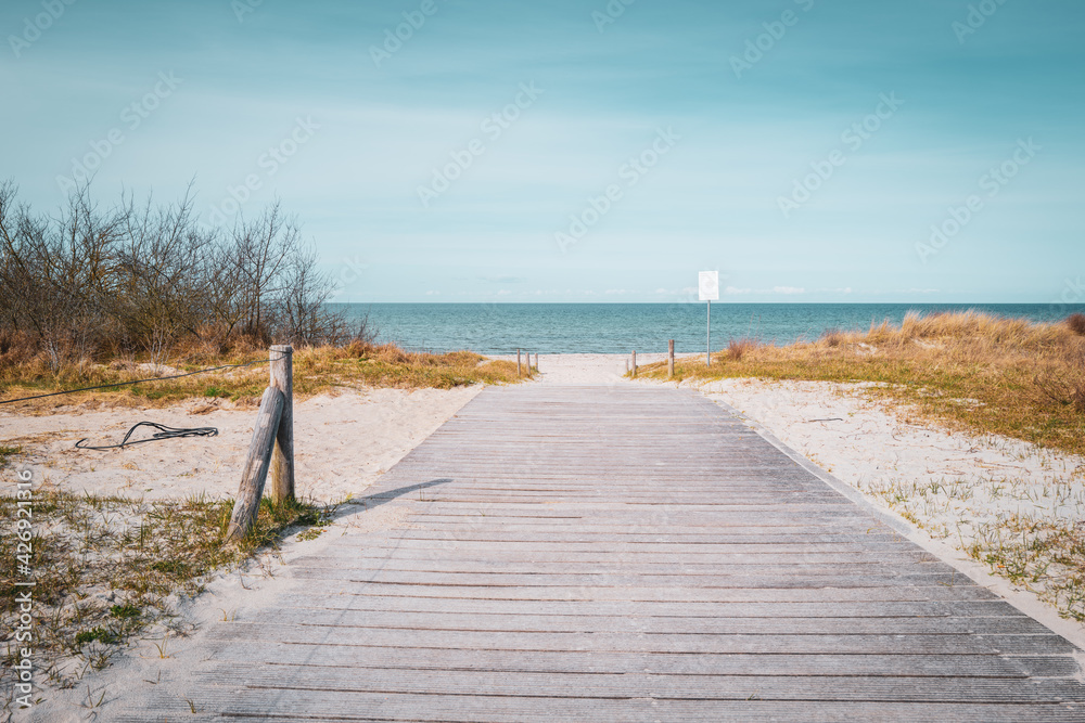 path leads to the blue water of the Baltic Sea and the sky is blue