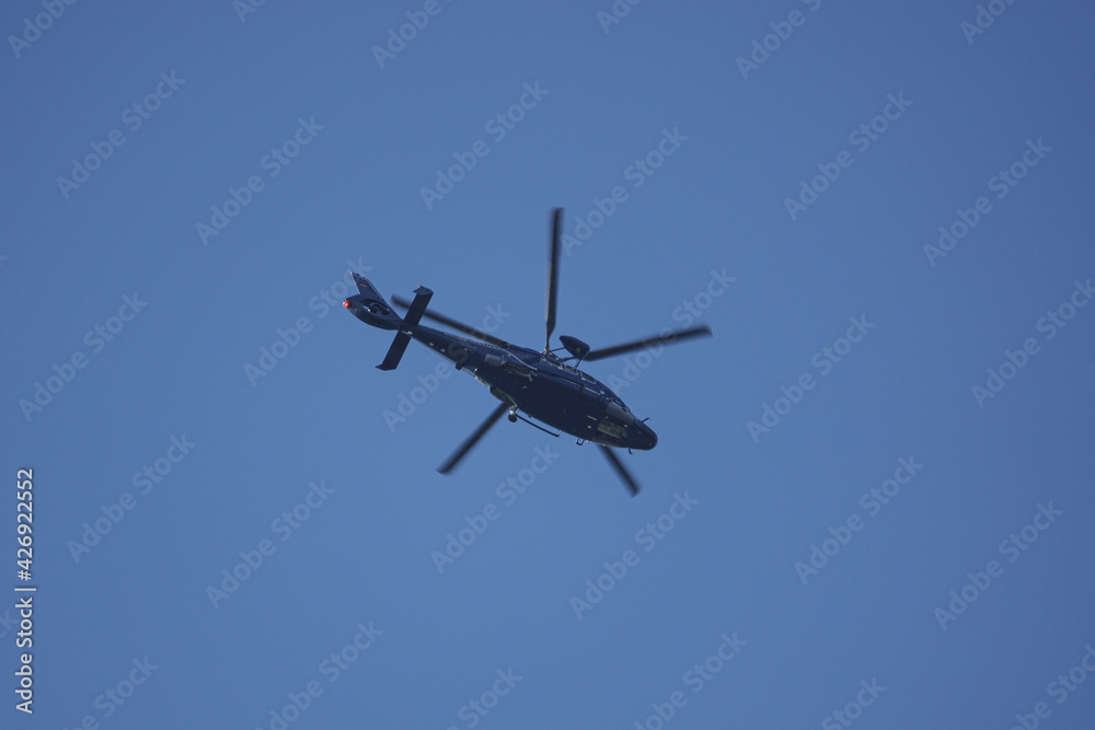 helicopter of the german federal police flies in the blue sky