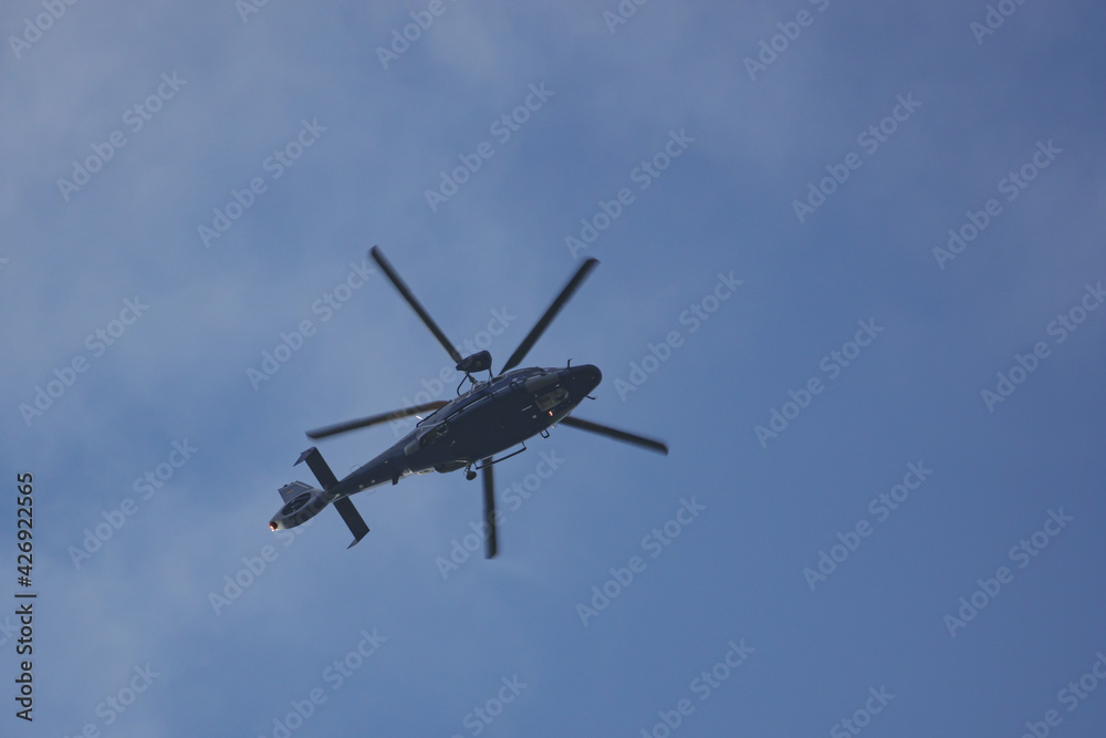 helicopter of the german federal police flies in the blue sky helicopter of the german federal police flies in the blue sky