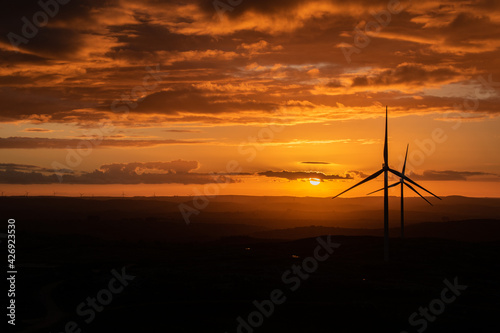 wind turbines at cloudy sunset