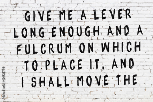Obraz na plátně White brick wall with painted black inscription of wise quote