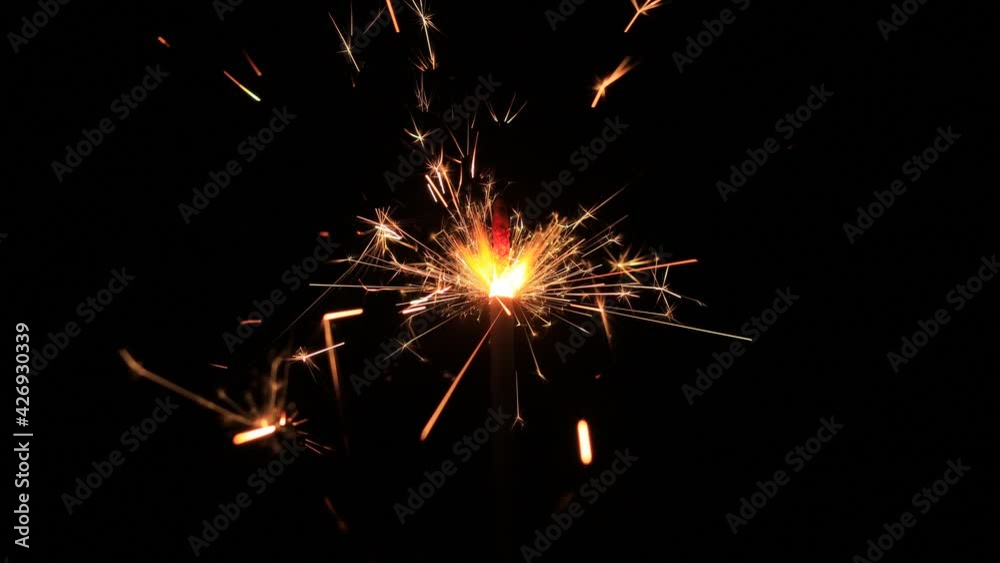 Christmas sparklers,Bengal lights on black background. Firework sparkler burning on dark background.Christmas or new year party glowing glowing burning sparkler Christmas sparklers,Bengal lights on black background. Firework sparkler burning on dark background.Christmas or new year party glowing glowing burning sparkler