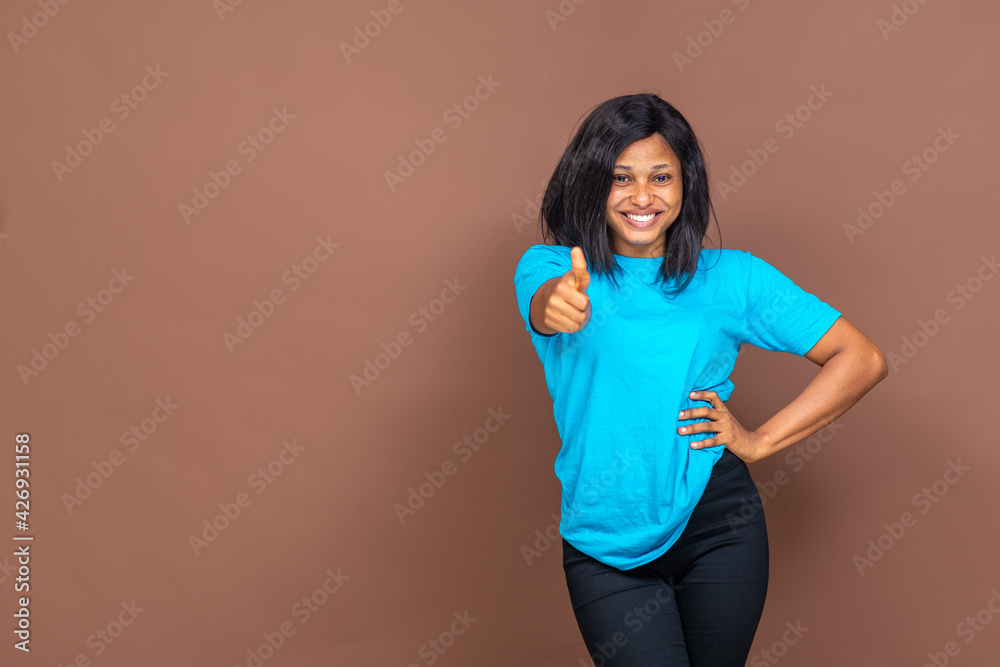 excited young black woman doing a thumbs up excited young black woman doing a thumbs up