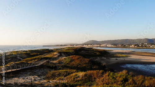 Aerial view of the Northern Litoral Natural Park in Ofir, Fao, Esposende, Portugal at sunset. The two sides of Restinga de Ofir. One facing the ocean, the other the estuary of Cávado River. photo