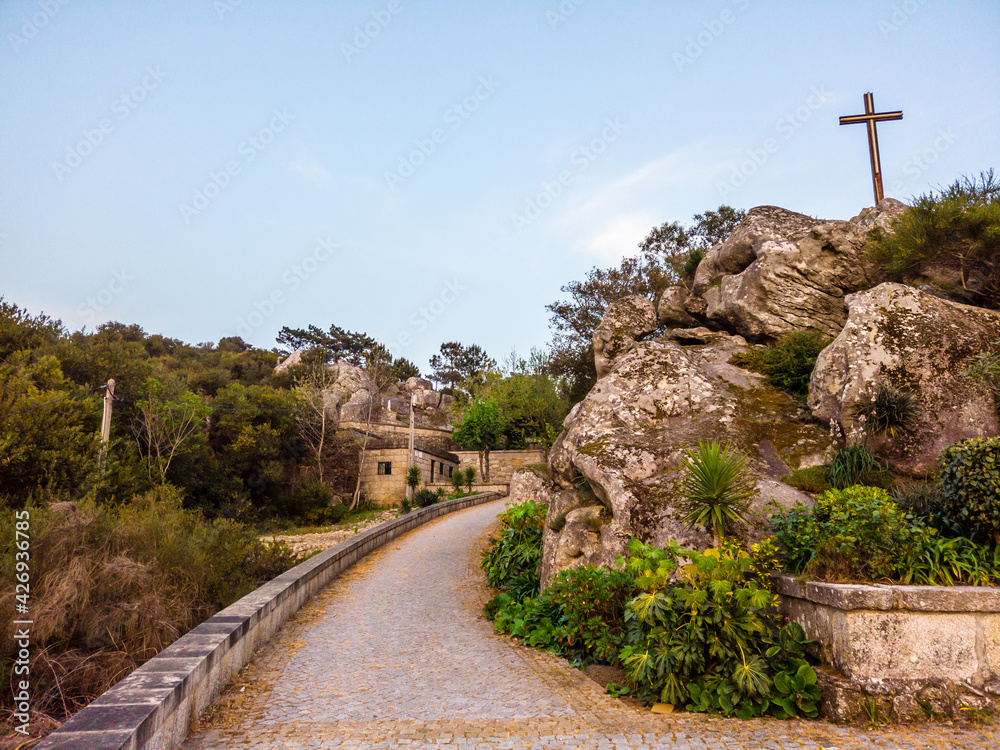 Fototapeta premium The Chapel of Our Lady of Guidance (Capela de Nossa Senhora da Guia), perched on a hill in the village of Belinho, this tiny shrine boasts incredible views of the mountains and the ocean.