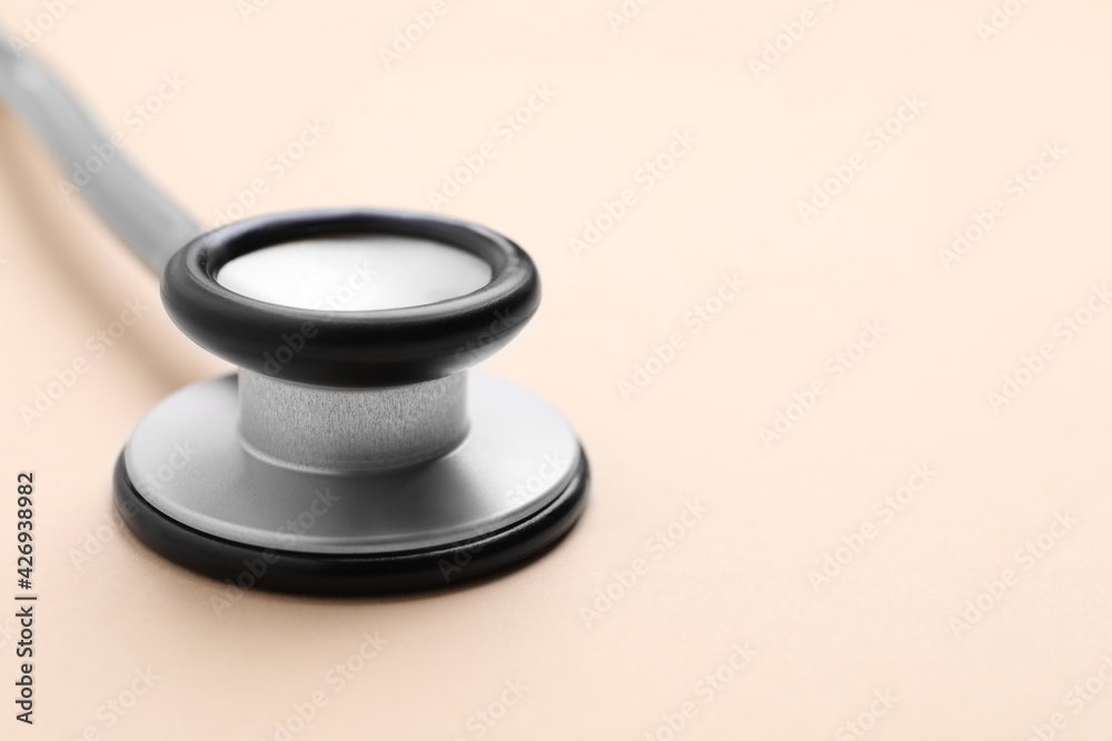 Stethoscope on beige background, closeup. Space for text Stethoscope on beige background, closeup. Space for text