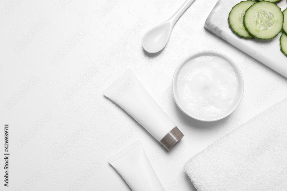 Flat lay composition with cream and cucumber slices on white table. Space for text Flat lay composition with cream and cucumber slices on white table. Space for text