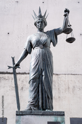 Фотография Statue of Lady Justice with the sword in one hand and the scales of justice in t