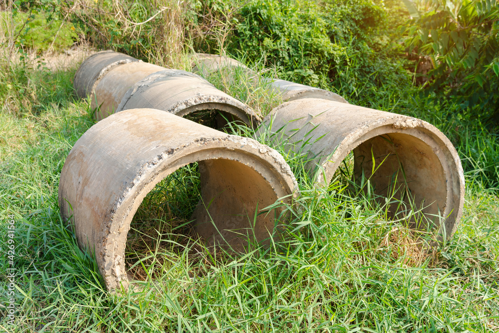 Reinforced concrete pipe for construction,Stacked concrete drainage pipes abstract. Reinforced concrete pipe for construction,Stacked concrete drainage pipes abstract.