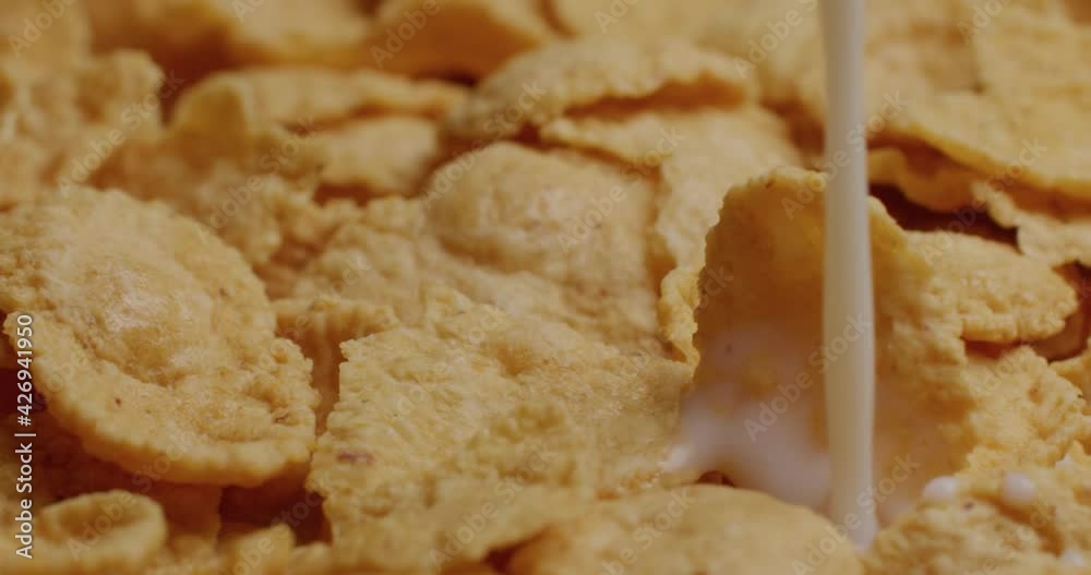 Pour milk into corn flake cereal Pour milk into corn flake cereal