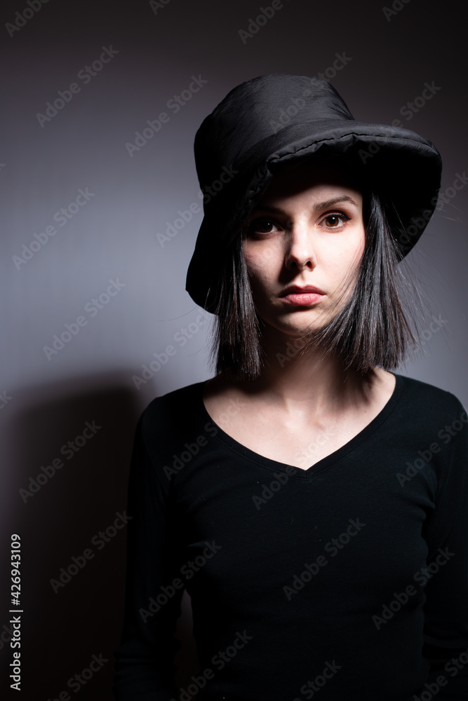 woman in black clothes on gray background woman in black clothes on gray background