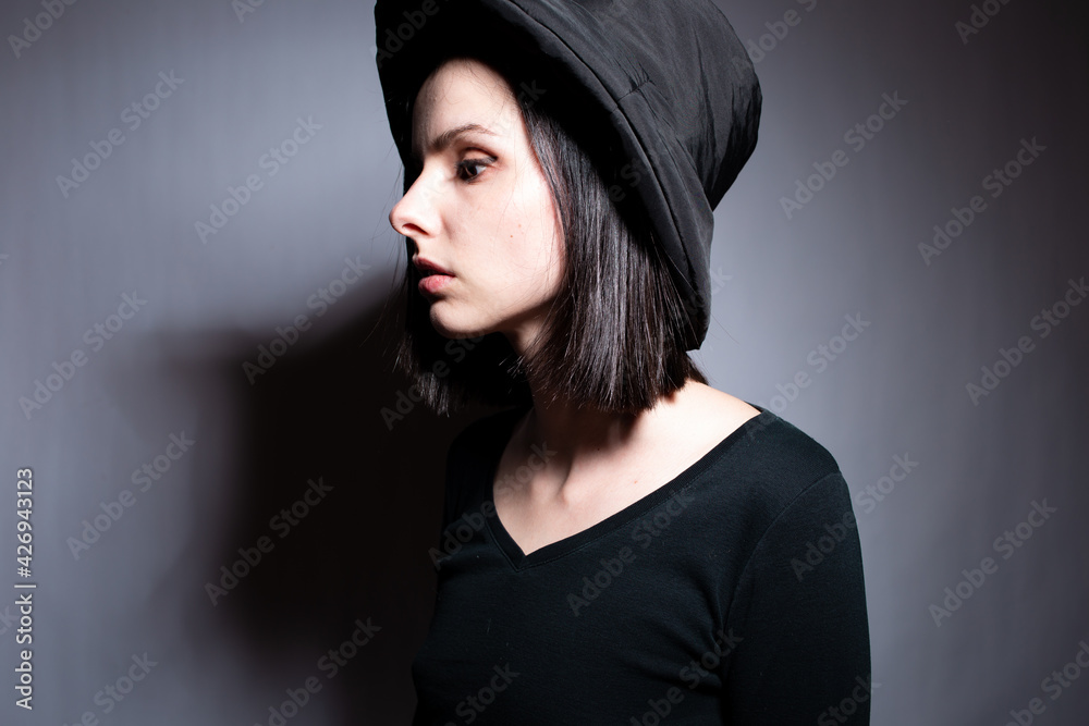 woman in black clothes on gray background woman in black clothes on gray background