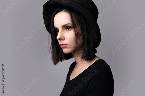 woman in black clothes on gray background
