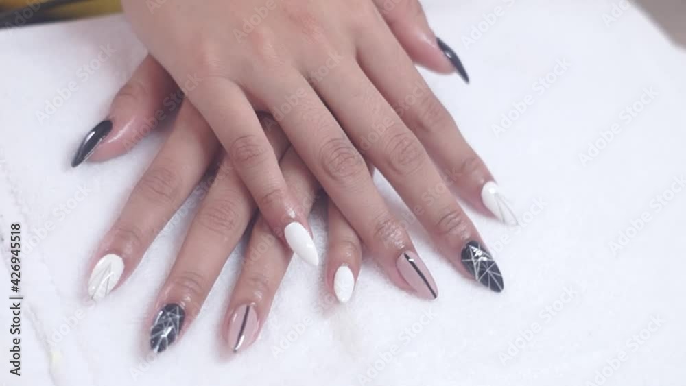 Women paints nails.Manicure Nail Art close up. Beautiful Nail Art Manicure. Nail designs with decoration.Manicure nail paint. Women paints nails.Manicure Nail Art close up. Beautiful Nail Art Manicure. Nail designs with decoration.Manicure nail paint.