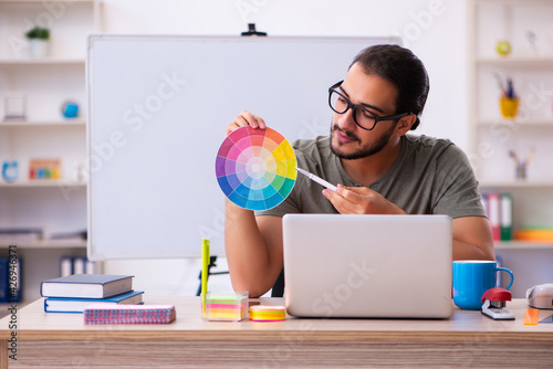 Young male designer working in the office