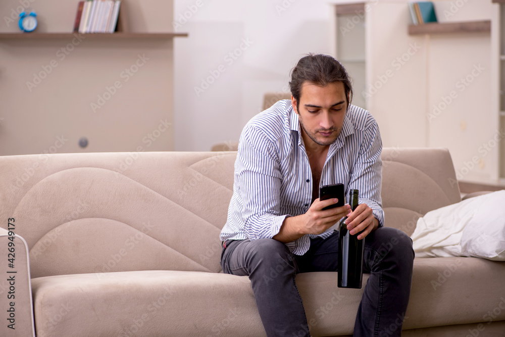 Young drunk man suffering at home Young drunk man suffering at home