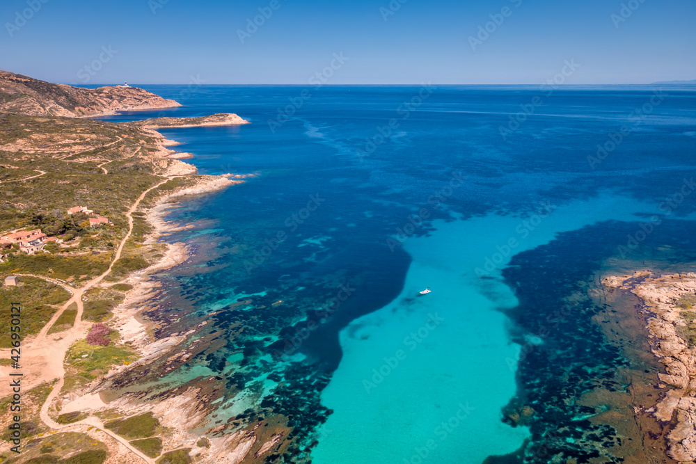 Aerial view of small boat in turquoise Mediterranean