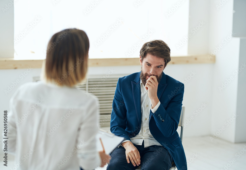 emotional man at the reception with a psychologist consultation Professional emotional man at the reception with a psychologist consultation Professional