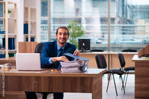 Young male employee working in the office