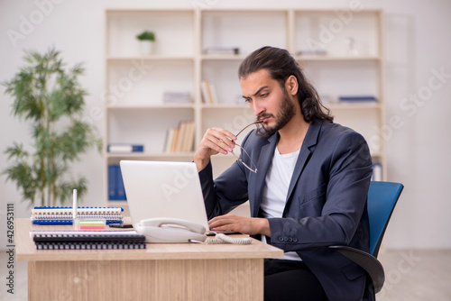 Young male employee working in the office