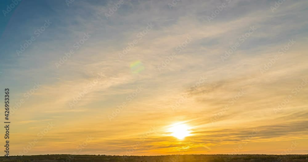 Beautiful evening sunset, time lapse, movement of clouds of a different level against the setting sun Beautiful evening sunset, time lapse, movement of clouds of a different level against the setting sun