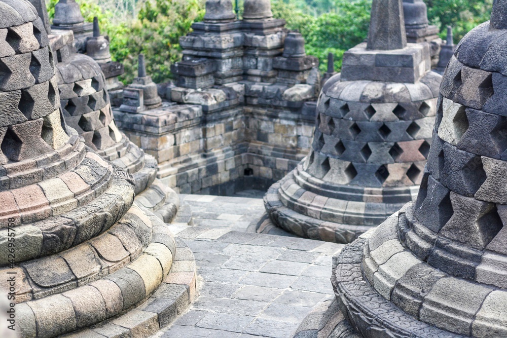 Interior of ancient Borobudur Temple. View of stupas on upper terrace. Popular tourist and Buddhist pilgrimage destination. No people. For wallpaper or background. Interior of ancient Borobudur Temple. View of stupas on upper terrace. Popular tourist and Buddhist pilgrimage destination. No people. For wallpaper or background.