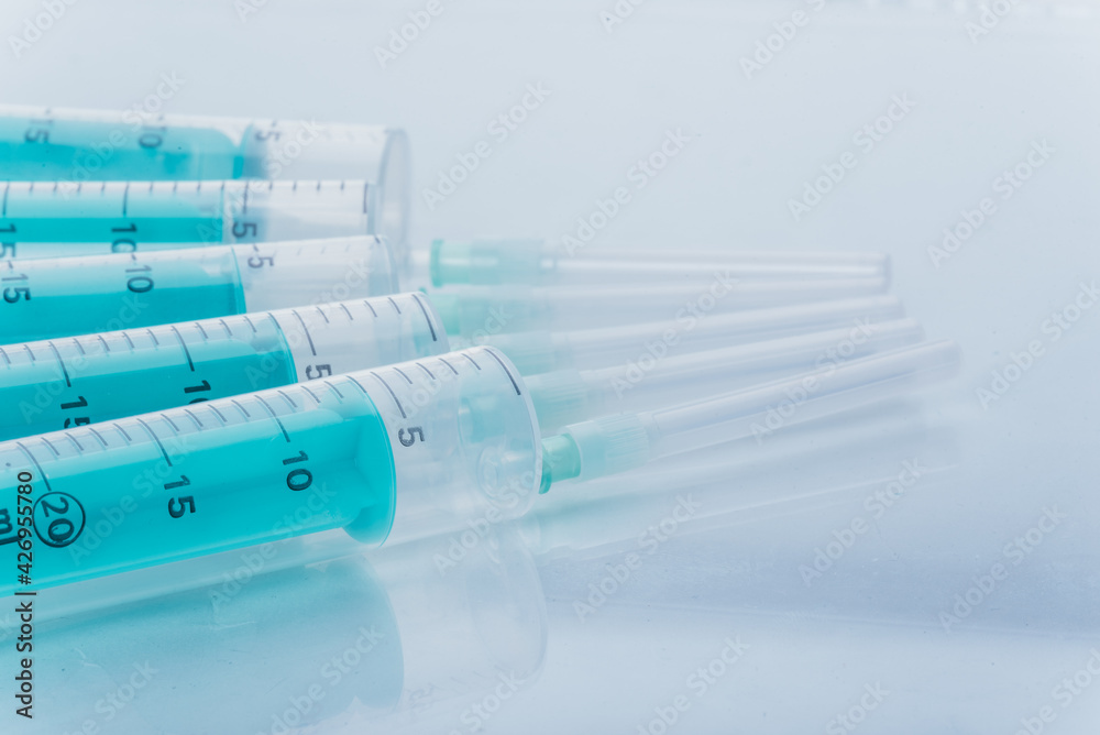 Medicine, Injection, vaccine and disposable syringe isolated, drug concept. Sterile vial medical. Macro close up on backgrounds gray.