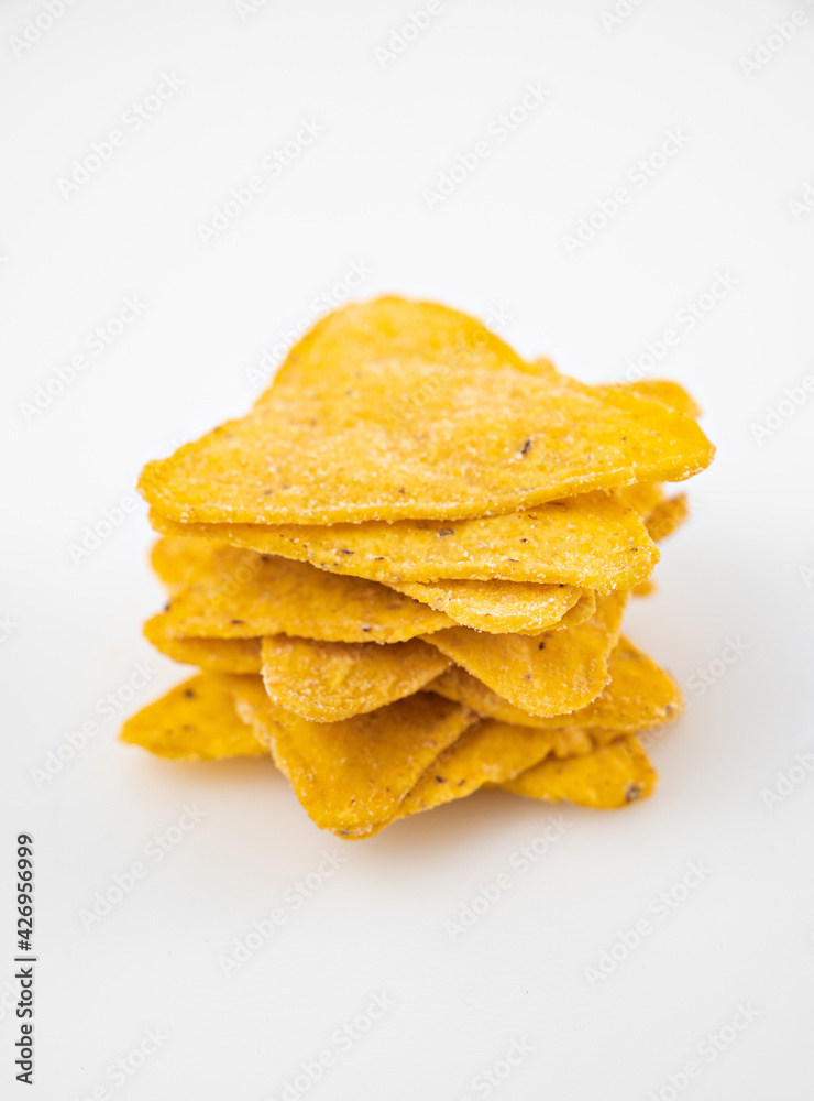 tower of Nachos on a white table. Mexican snack, corn tortilla chips. tower of Nachos on a white table. Mexican snack, corn tortilla chips.