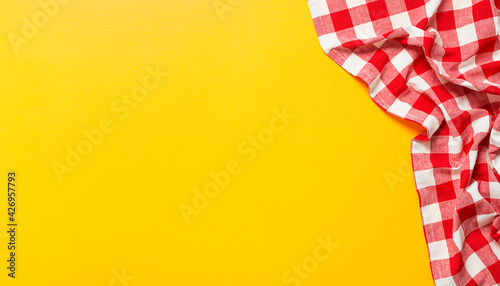 Yellow table covered with red tablecloth . View from top. Empty tablecloth for product montage. Free space for your text