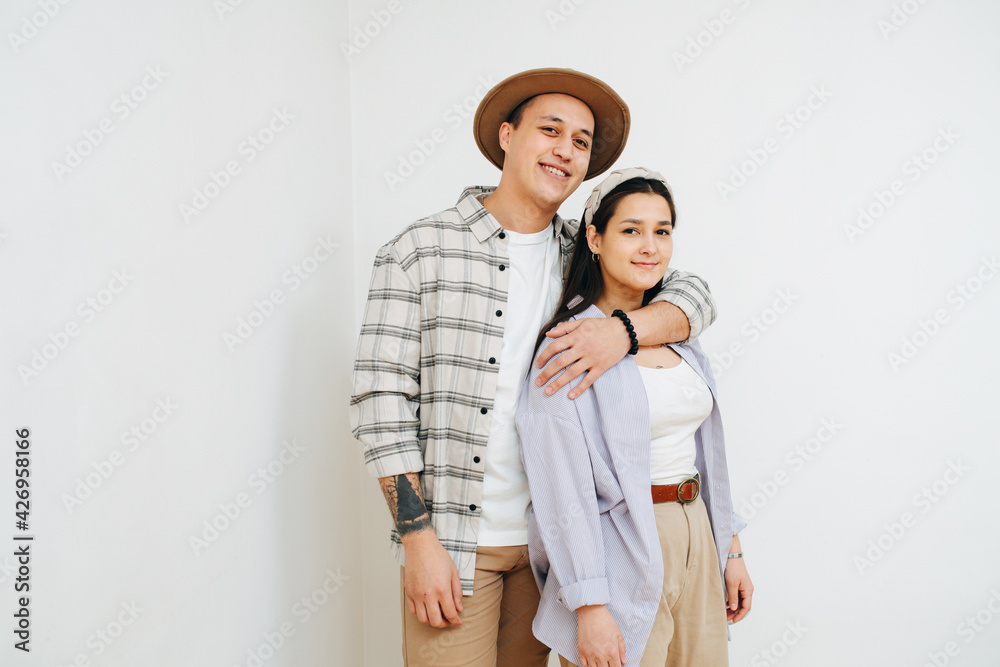 Loving young couple. Man is hugging woman from behind. Loving young couple. Man is hugging woman from behind.