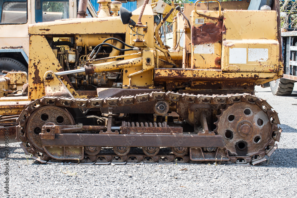 steel tracks old weathered excavator in worksite.