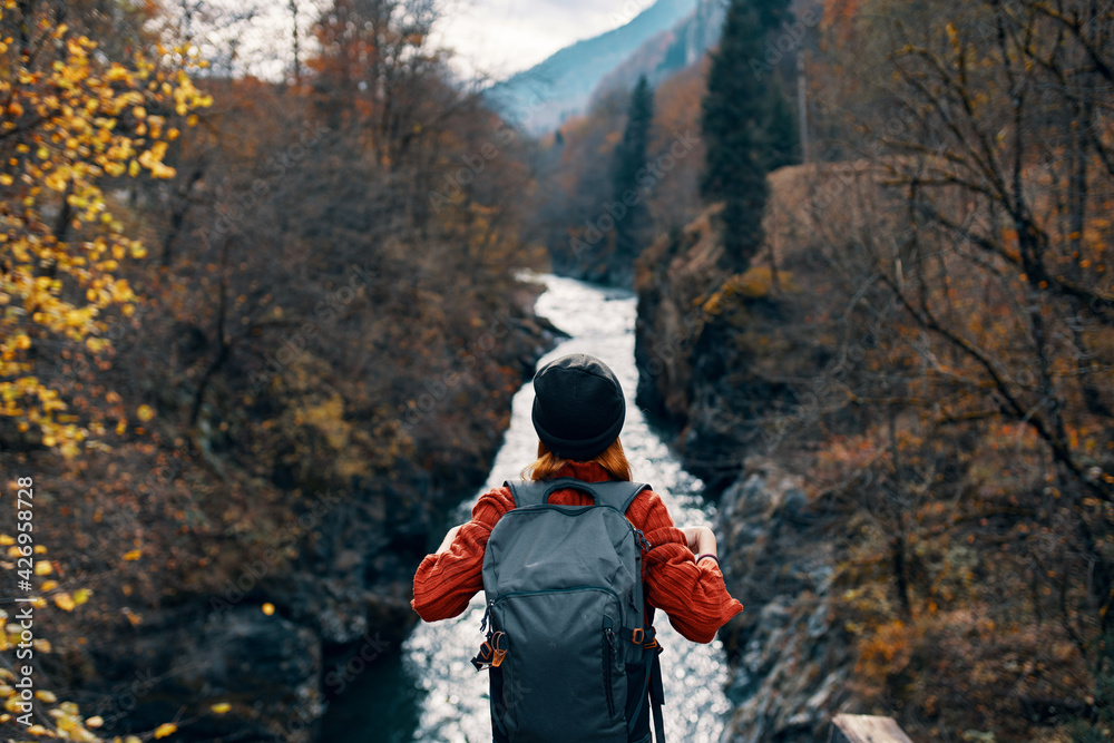 woman tourist stands on the bridge over the river or admires the nature landscape woman tourist stands on the bridge over the river or admires the nature landscape