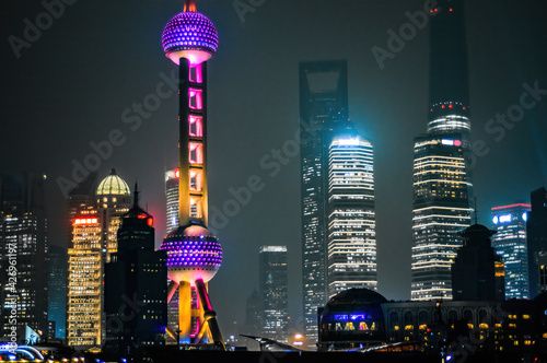 Oriental Pearl TV Tower lights on at night around Bund areal in Shanghai, China