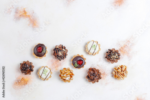 Various homemade mini tartlets with nuts and chocolate cream.