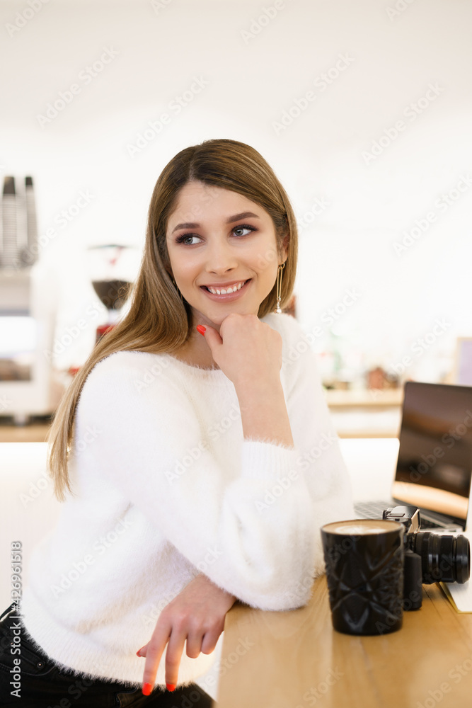Portrait of beautiful photographer woman working in office holding camera with laptop. Bloger freelance online marketing. Portrait of beautiful photographer woman working in office holding camera with laptop. Bloger freelance online marketing.