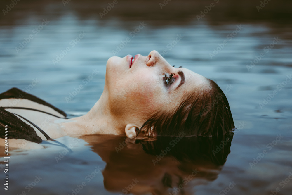 Fototapeta premium face girl lying in the water