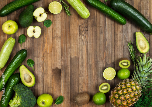 fresh tasty vegetables and fruits on a wooden background. space for text 