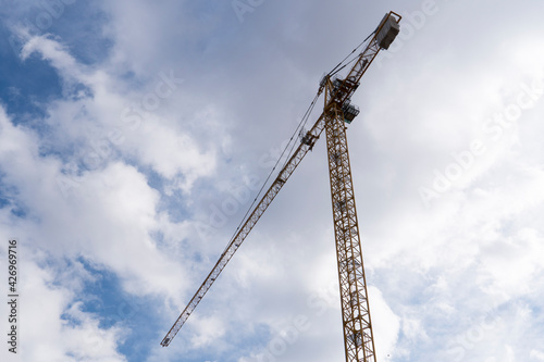 Tower crane on blue cloudy skies background