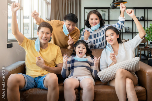 stay strong healthy asian family multi generation wearing virus protective face mask stay quarantane together at living room home background social distacing new normal lifestyle
