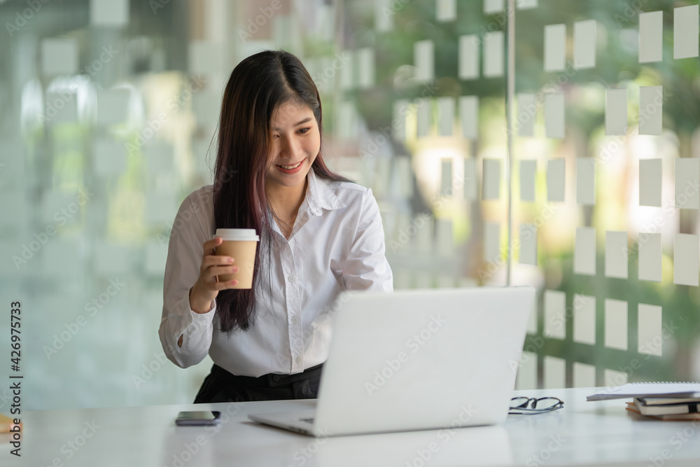businesswoman having tea or coffee in home office. businesswoman having tea or coffee in home office.