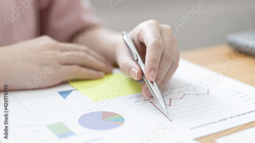 Businessmen working in the office using the expense and budget accounting calculator with graphs as a measure of the company's growth, financial and accounting concepts.