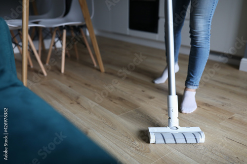Woman washes floor with mop. Services of cleaning companies
