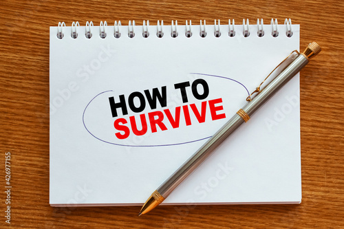 Wallpaper Mural Notepad with inscriptions HOW TO SURVIVE on a white background. business concept. Torontodigital.ca