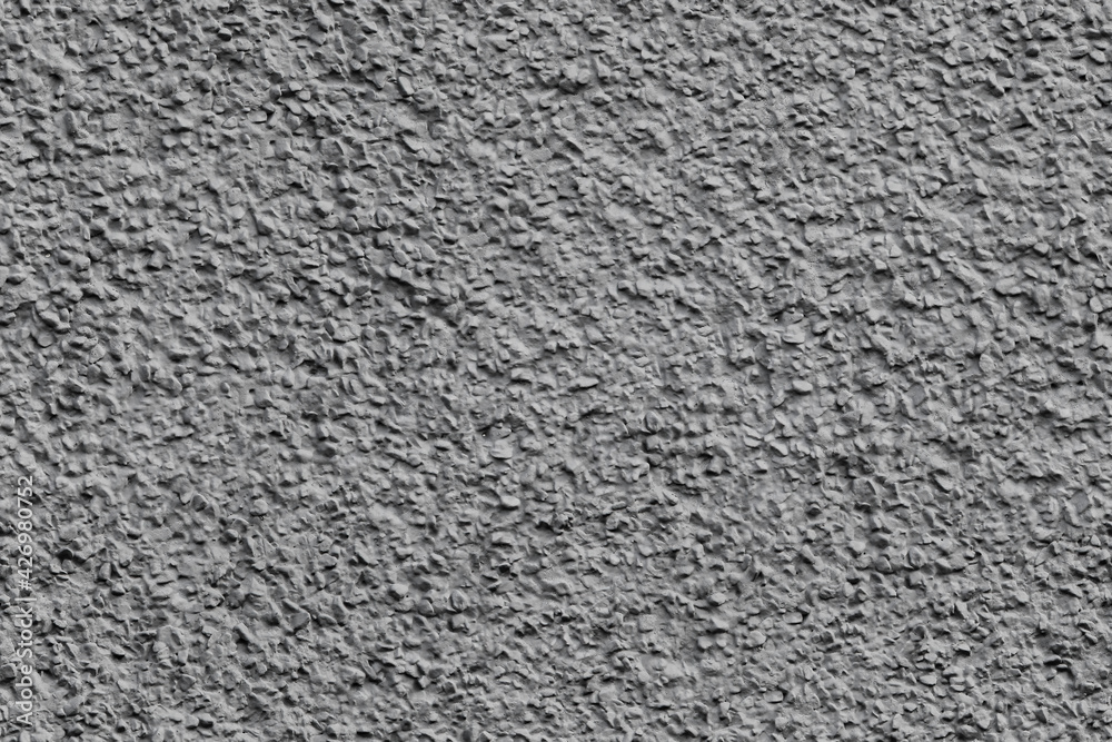 Stucco - seamless texture, photo. Gray Plaster rough facade finish. Natural stone covered with cement mortar. 