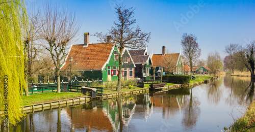 Traditional dutch wooden houses reflected in the canal in Zaanse Schans, Netherlands